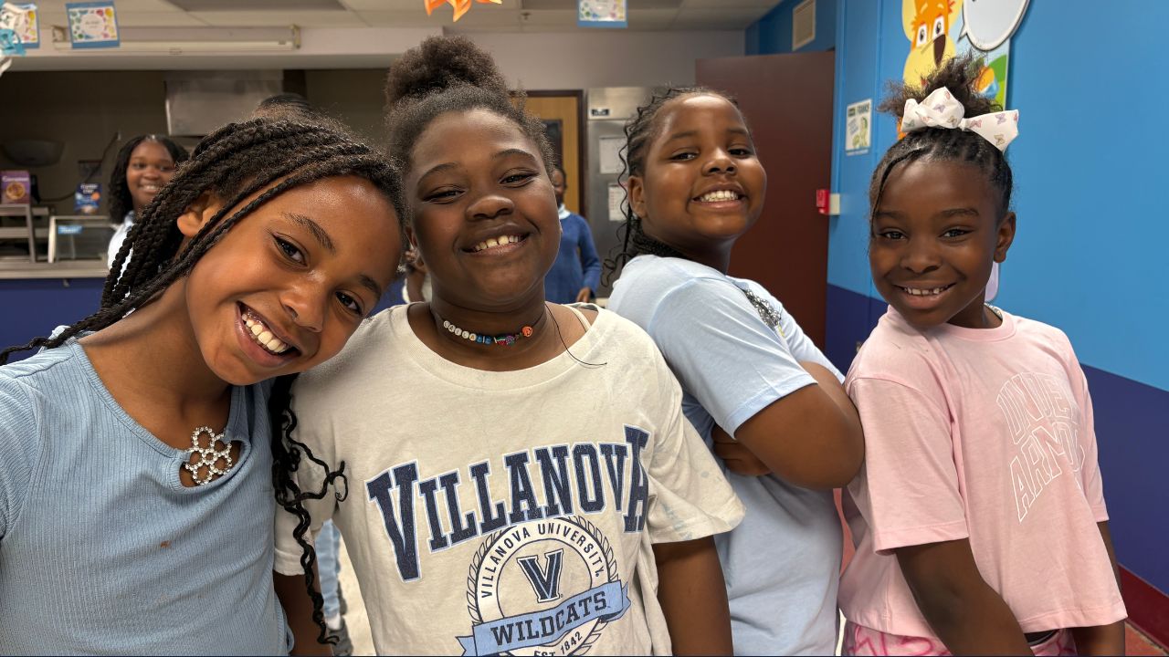 4 students smiling