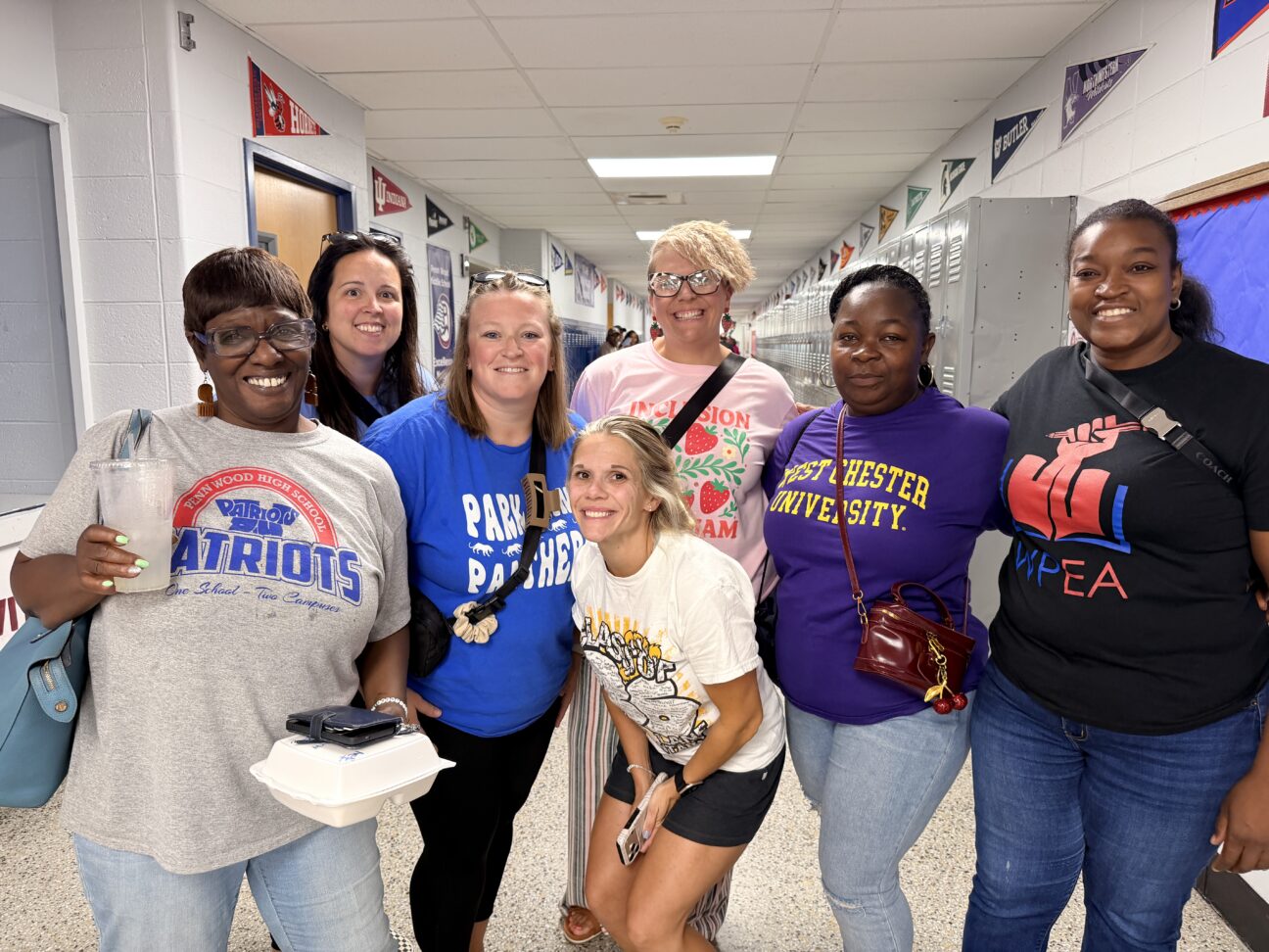 A group of smiling William Penn School District staff members.